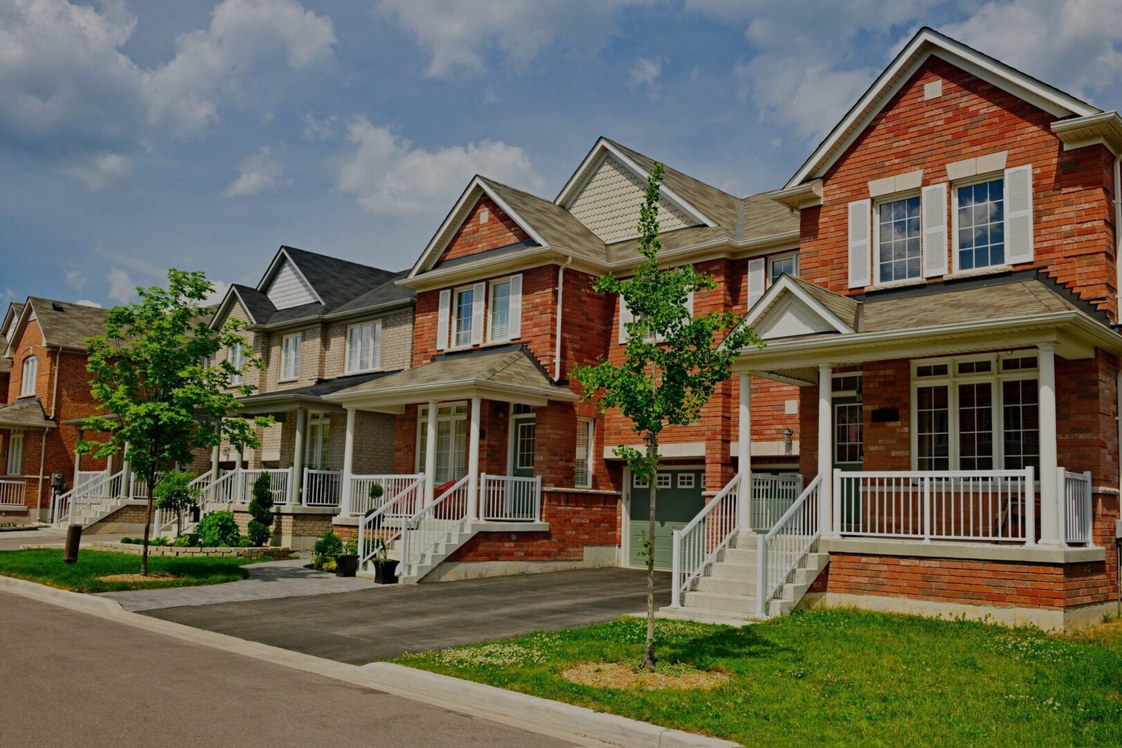 A row of houses with steps leading to the front.