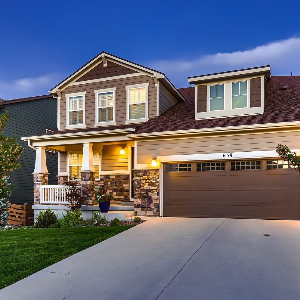 Modern suburban house with landscaped front yard.
